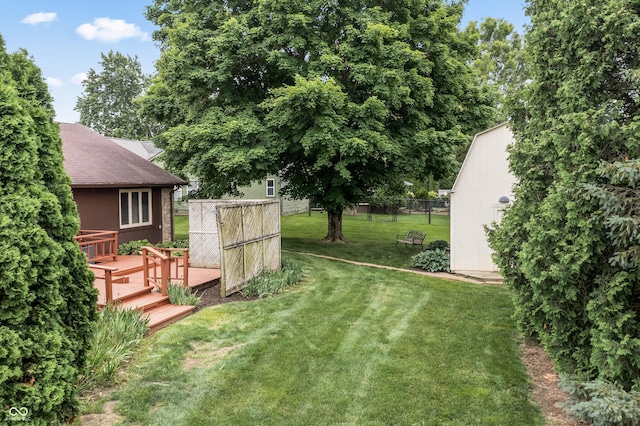 7426 N Carroll Rd, Indianapolis, IN 46236 - view of yard with a wooden deck and an outdoor structure