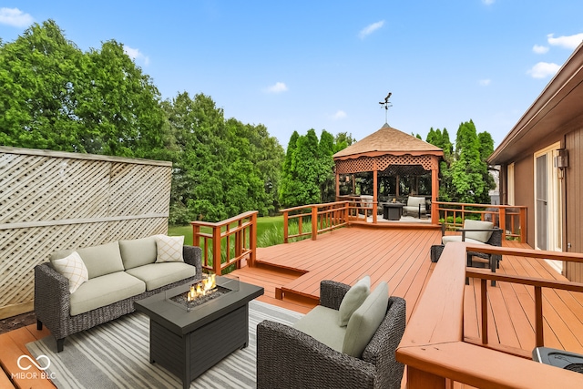 7426 N Carroll Rd, Indianapolis, IN 46236 - deck featuring an outdoor living space with a fire pit, a gazebo, and view of wooded area