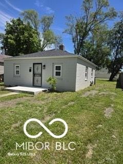 2421 N Arsenal Ave, Indianapolis, IN 46218 - view of front of property featuring a front lawn and stucco siding