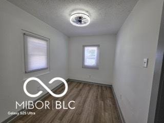 2421 N Arsenal Ave, Indianapolis, IN 46218 - empty room with wood finished floors, baseboards, and a textured ceiling