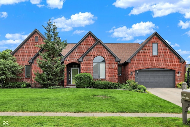 14492 Allison Dr, Carmel, IN 46033 - english style home featuring brick siding, concrete driveway, a front lawn, and roof with shingles