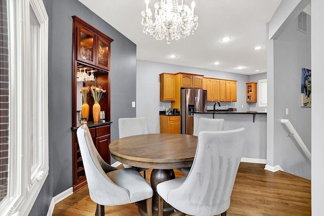 14492 Allison Dr, Carmel, IN 46033 - dining area featuring a chandelier, wood finished floors, recessed lighting, and baseboards