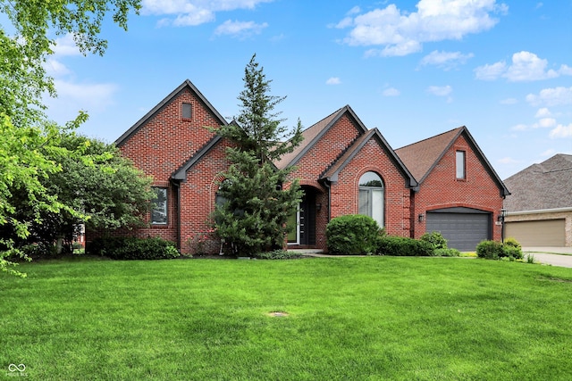 14492 Allison Dr, Carmel, IN 46033 - tudor home featuring brick siding, a front lawn, driveway, and an attached garage