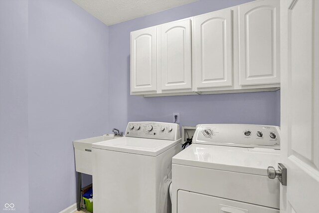 14492 Allison Dr, Carmel, IN 46033 - laundry room featuring washing machine and clothes dryer and cabinet space