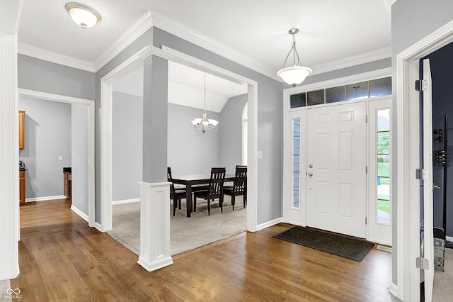 14492 Allison Dr, Carmel, IN 46033 - foyer entrance with wood finished floors, baseboards, a chandelier, ornamental molding, and vaulted ceiling