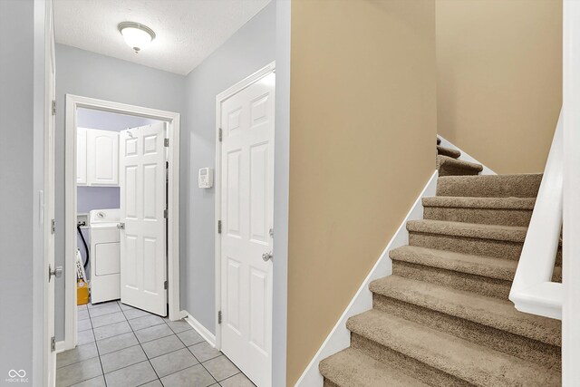 14492 Allison Dr, Carmel, IN 46033 - stairs with washer / clothes dryer, tile patterned flooring, baseboards, and a textured ceiling