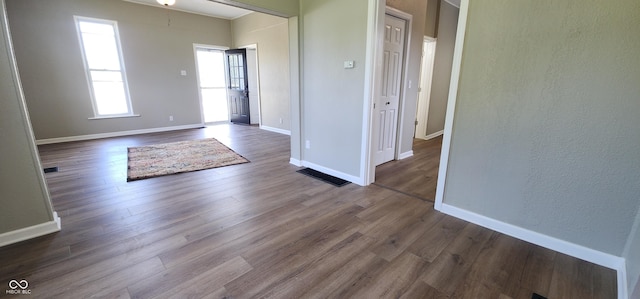 709 N Sterling Ave, Veedersburg, IN 47987 - foyer entrance featuring dark wood-style flooring, baseboards, and a textured wall