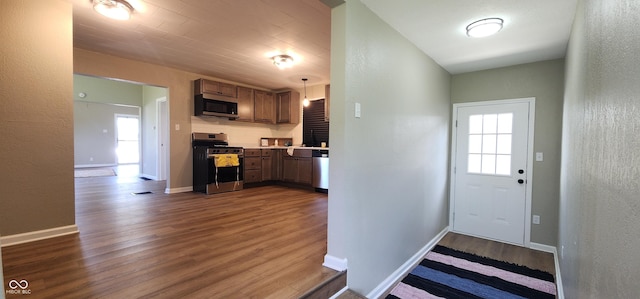 709 N Sterling Ave, Veedersburg, IN 47987 - kitchen with appliances with stainless steel finishes, dark wood-style floors, a textured wall, light countertops, and baseboards