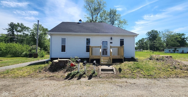 709 N Sterling Ave, Veedersburg, IN 47987 - back of property featuring roof with shingles and a wooden deck