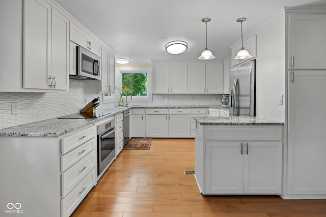 3503 S 9th St, Lafayette, IN 47909 - kitchen with stainless steel appliances, backsplash, light wood-type flooring, white cabinets, and crown molding