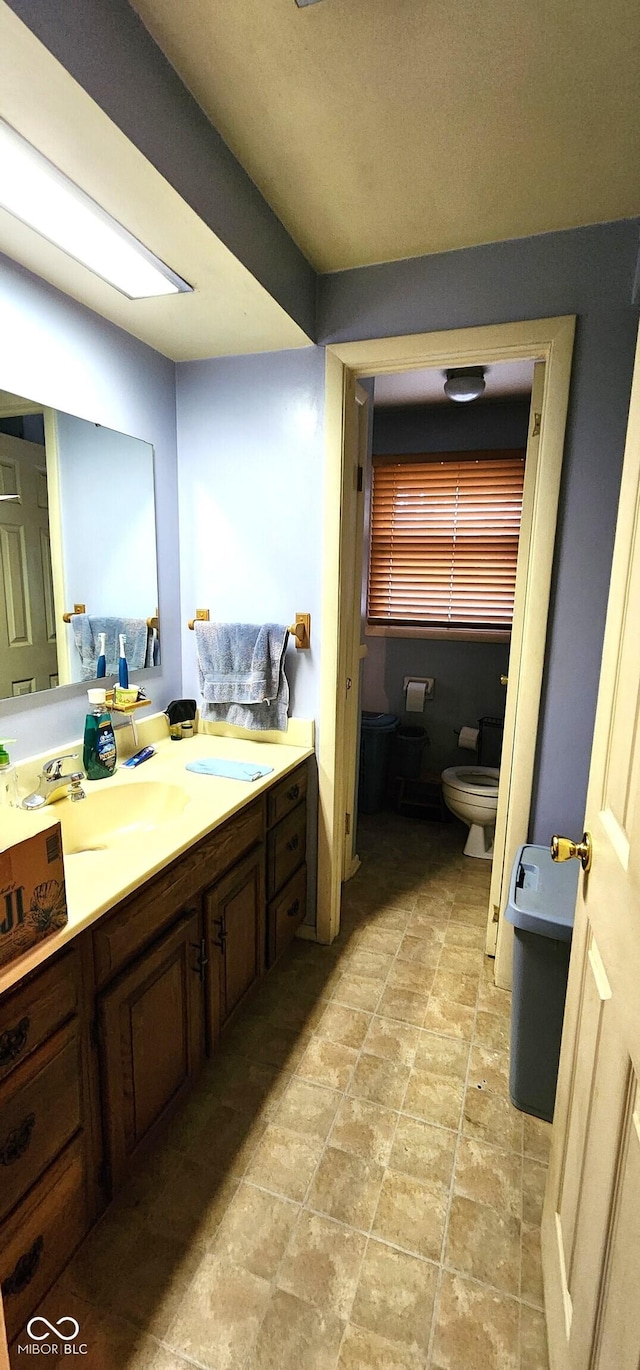 1619 Crest Ct, Indianapolis, IN 46214 - bathroom with toilet, vanity, a bidet, and stone finish floors
