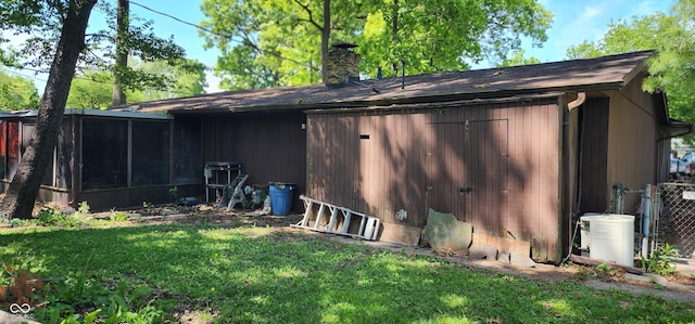 1619 Crest Ct, Indianapolis, IN 46214 - back of property featuring a chimney and a sunroom
