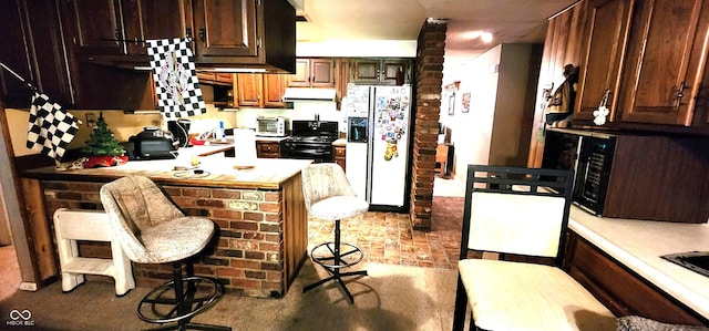1619 Crest Ct, Indianapolis, IN 46214 - kitchen featuring black appliances, under cabinet range hood, light countertops, a peninsula, and dark brown cabinetry
