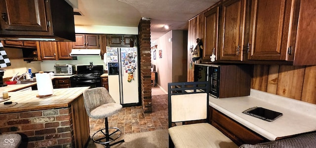 1619 Crest Ct, Indianapolis, IN 46214 - kitchen with black appliances, under cabinet range hood, a breakfast bar area, tile countertops, and dark brown cabinetry
