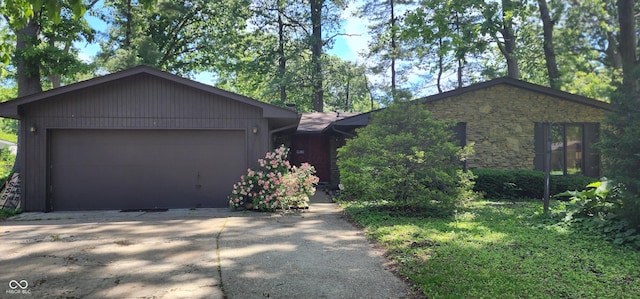 1619 Crest Ct, Indianapolis, IN 46214 - view of front of property with driveway, a garage, and stone siding