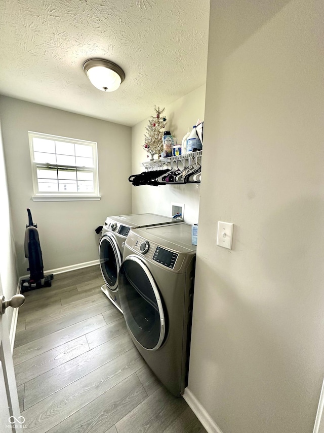 9133 Thames Dr, Avon, IN 46123 - washroom featuring separate washer and dryer, wood finished floors, baseboards, and a textured ceiling