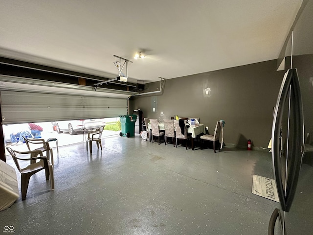 9133 Thames Dr, Avon, IN 46123 - garage featuring freestanding refrigerator and a garage door opener