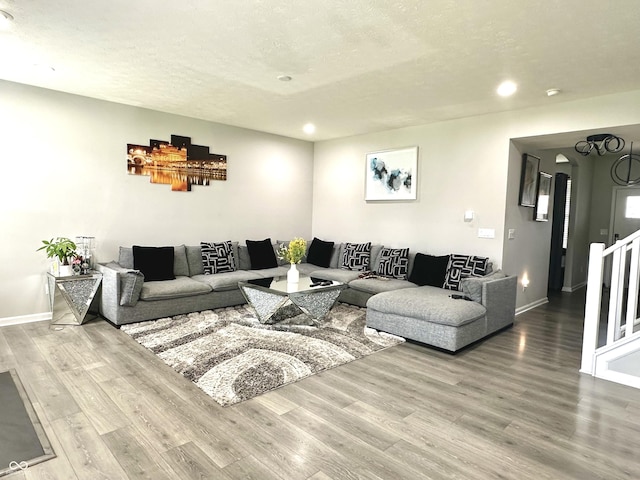 9133 Thames Dr, Avon, IN 46123 - living room featuring wood finished floors, recessed lighting, baseboards, a textured ceiling, and stairway
