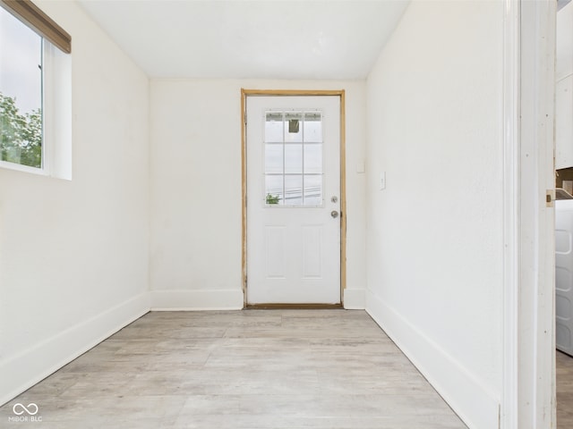 907 S A St, Elwood, IN 46036 - doorway to outside featuring healthy amount of natural light, light wood-style flooring, and baseboards
