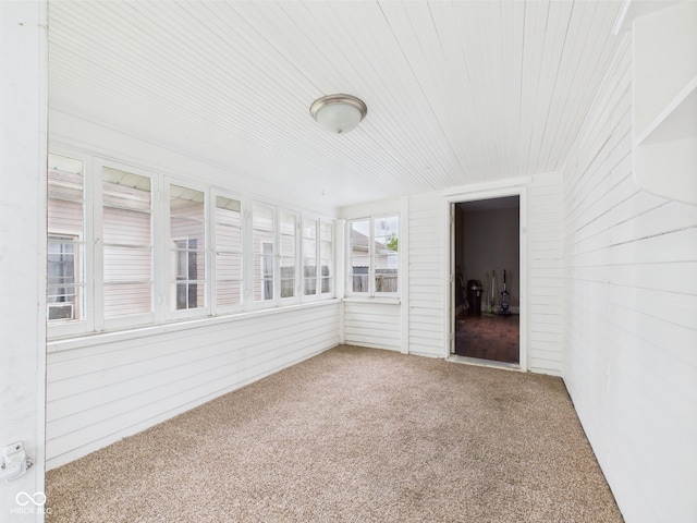 907 S A St, Elwood, IN 46036 - unfurnished sunroom featuring carpet floors, wooden ceiling, and wood walls