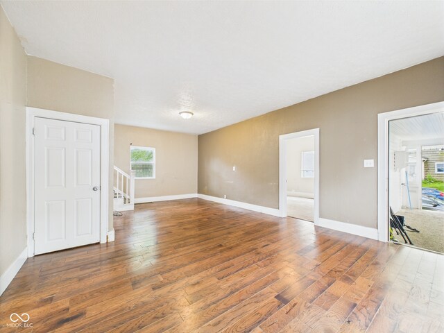 907 S A St, Elwood, IN 46036 - spare room with wood finished floors, stairs, and baseboards