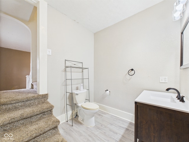 907 S A St, Elwood, IN 46036 - bathroom with vanity, wood finished floors, baseboards, and toilet