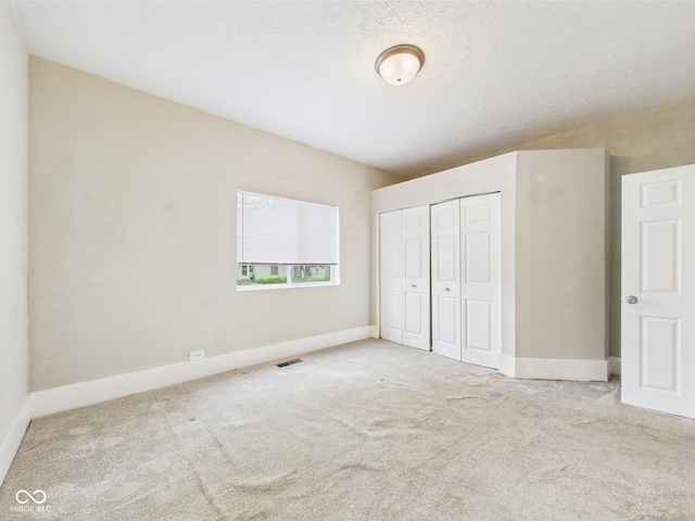 907 S A St, Elwood, IN 46036 - unfurnished bedroom with carpet floors, a closet, and baseboards