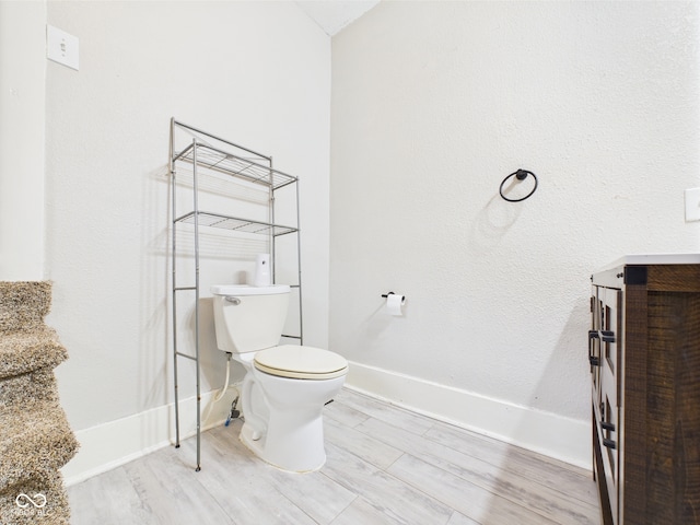 907 S A St, Elwood, IN 46036 - half bath featuring toilet, baseboards, and wood finished floors
