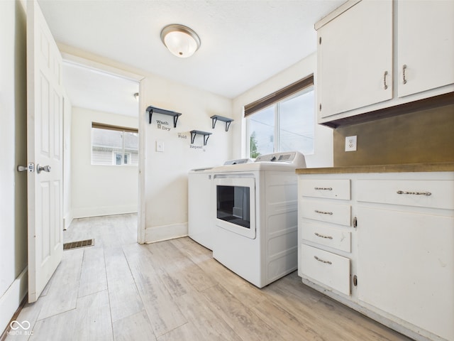 907 S A St, Elwood, IN 46036 - laundry area featuring separate washer and dryer, light wood-type flooring, cabinet space, and baseboards