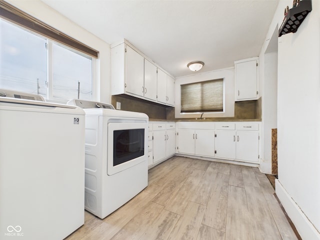 907 S A St, Elwood, IN 46036 - laundry room with cabinet space, light wood-type flooring, and washing machine and dryer