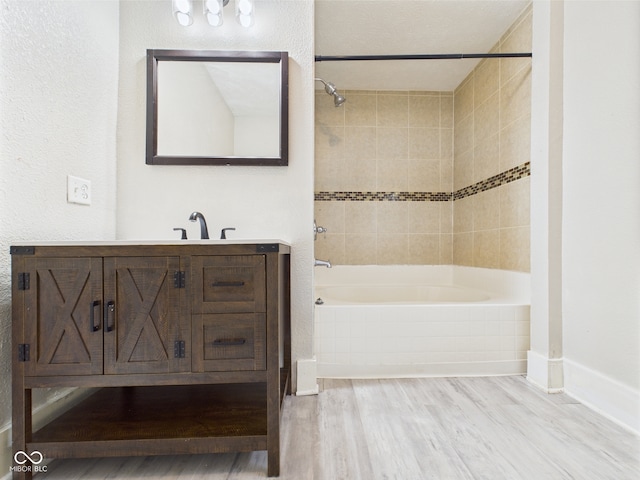 907 S A St, Elwood, IN 46036 - full bath featuring wood finished floors,  shower combination, vanity, and baseboards