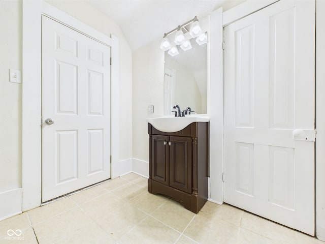 907 S A St, Elwood, IN 46036 - bathroom featuring lofted ceiling, vanity, tile patterned flooring, and baseboards