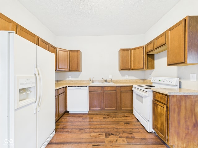907 S A St, Elwood, IN 46036 - kitchen with white appliances, a sink, dark wood-style floors, brown cabinets, and a textured ceiling