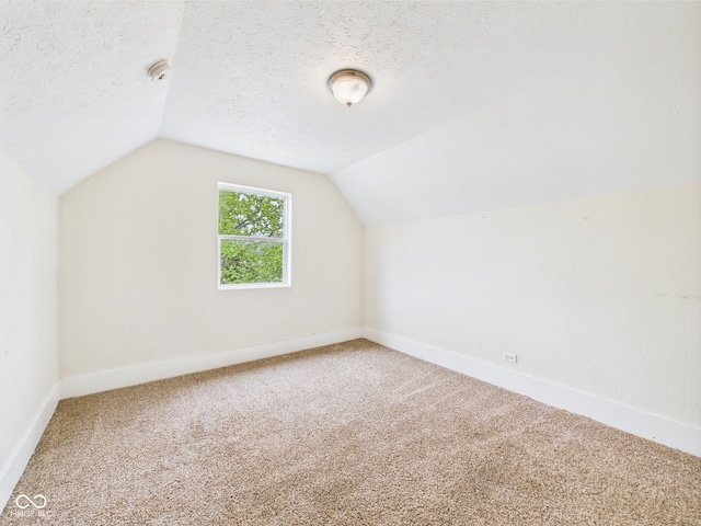 907 S A St, Elwood, IN 46036 - additional living space with lofted ceiling, carpet, and baseboards