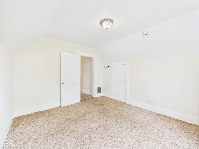 907 S A St, Elwood, IN 46036 - additional living space with lofted ceiling, carpet flooring, and baseboards
