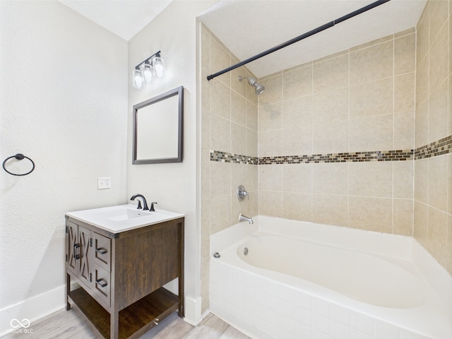 907 S A St, Elwood, IN 46036 - full bathroom with vanity, shower / washtub combination, baseboards, and wood finished floors