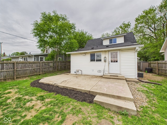 907 S A St, Elwood, IN 46036 - rear view of house featuring a patio area, a fenced backyard, and a shingled roof