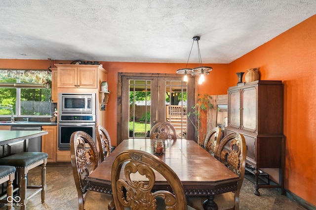 3480 W Broadus Dr, North Vernon, IN 47265 - dining area featuring a textured ceiling and french doors