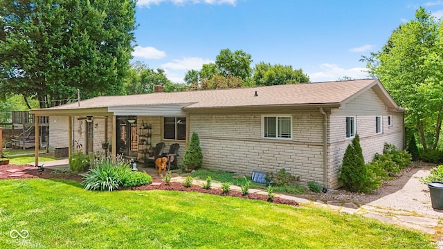 3480 W Broadus Dr, North Vernon, IN 47265 - view of front of home featuring a front yard, a chimney, a patio area, brick siding, and roof with shingles