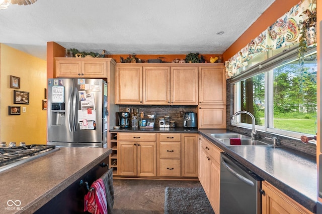 3480 W Broadus Dr, North Vernon, IN 47265 - kitchen featuring stainless steel appliances, a sink, a textured ceiling, dark countertops, and decorative backsplash