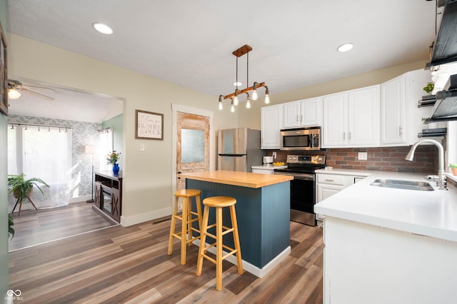 3360 Main St, Plainfield, IN 46168 - kitchen with stainless steel appliances, wood counters, a sink, a center island, and white cabinets