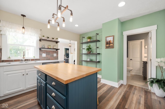 3360 Main St, Plainfield, IN 46168 - kitchen featuring open shelves, wooden counters, blue cabinets, white cabinetry, and a sink