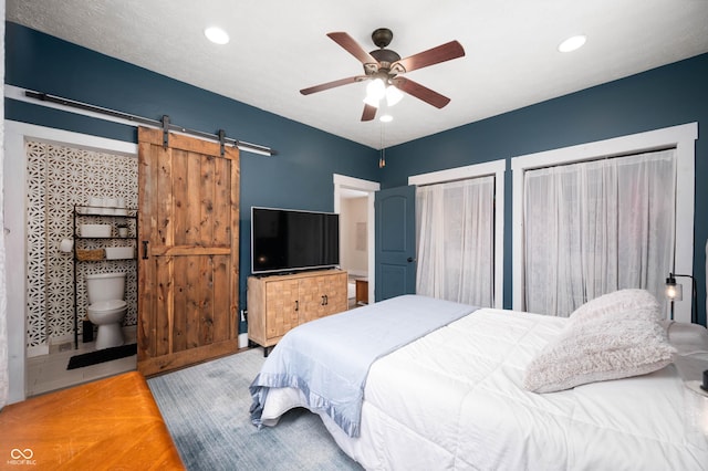 3360 Main St, Plainfield, IN 46168 - bedroom with a barn door, recessed lighting, ceiling fan, ensuite bath, and two closets