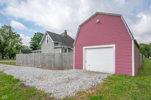 3360 Main St, Plainfield, IN 46168 - view of property exterior featuring gravel driveway, an outdoor structure, a garage, and a gambrel roof