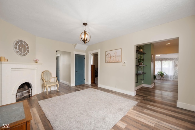 3360 Main St, Plainfield, IN 46168 - living room with wood finished floors, baseboards, a chandelier, and a fireplace