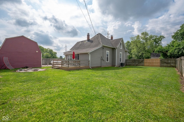 3360 Main St, Plainfield, IN 46168 - rear view of house featuring a deck, an outbuilding, a chimney, central AC unit, and a barn
