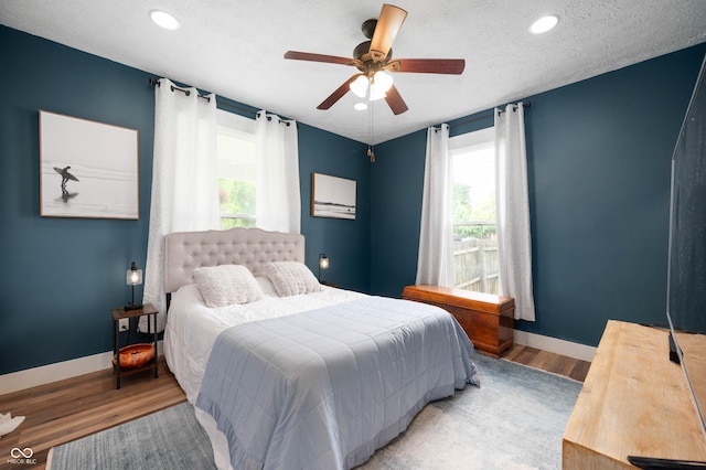 3360 Main St, Plainfield, IN 46168 - bedroom with multiple windows, wood finished floors, baseboards, recessed lighting, and a textured ceiling
