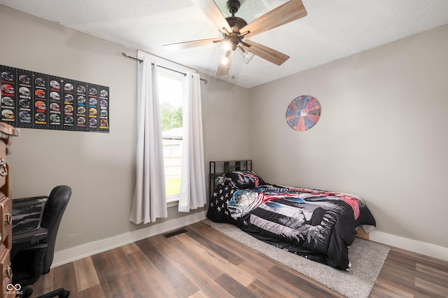 3360 Main St, Plainfield, IN 46168 - bedroom with baseboards, wood finished floors, an office area, a ceiling fan, and a textured ceiling