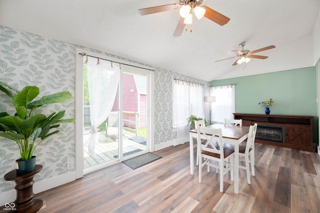 3360 Main St, Plainfield, IN 46168 - dining area with wallpapered walls, lofted ceiling, wood finished floors, ceiling fan, and baseboards