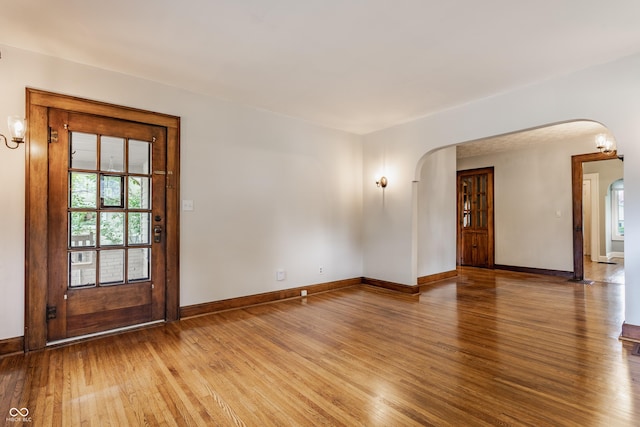595 W Poplar St, Zionsville, IN 46077 - spare room featuring arched walkways, plenty of natural light, light wood finished floors, and baseboards